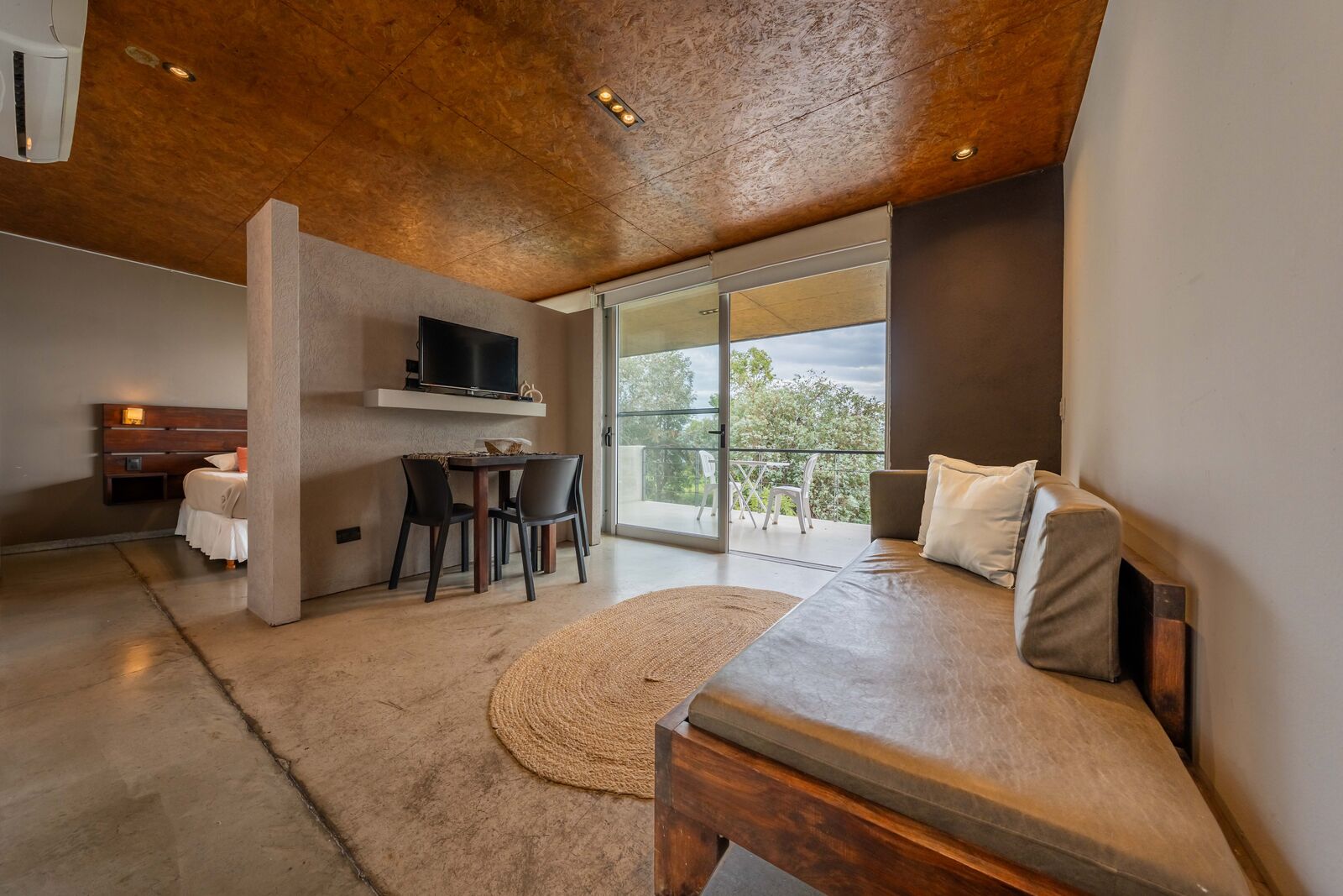 Sitting area of the studio with the veranda and Lake Los Molinos beyond
